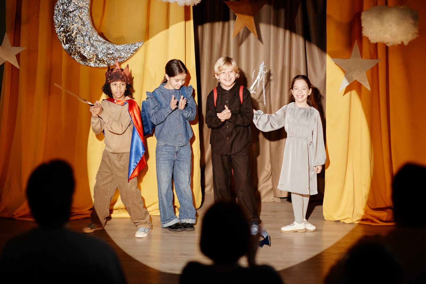 Kids Performing On Stage In Bright Costumes